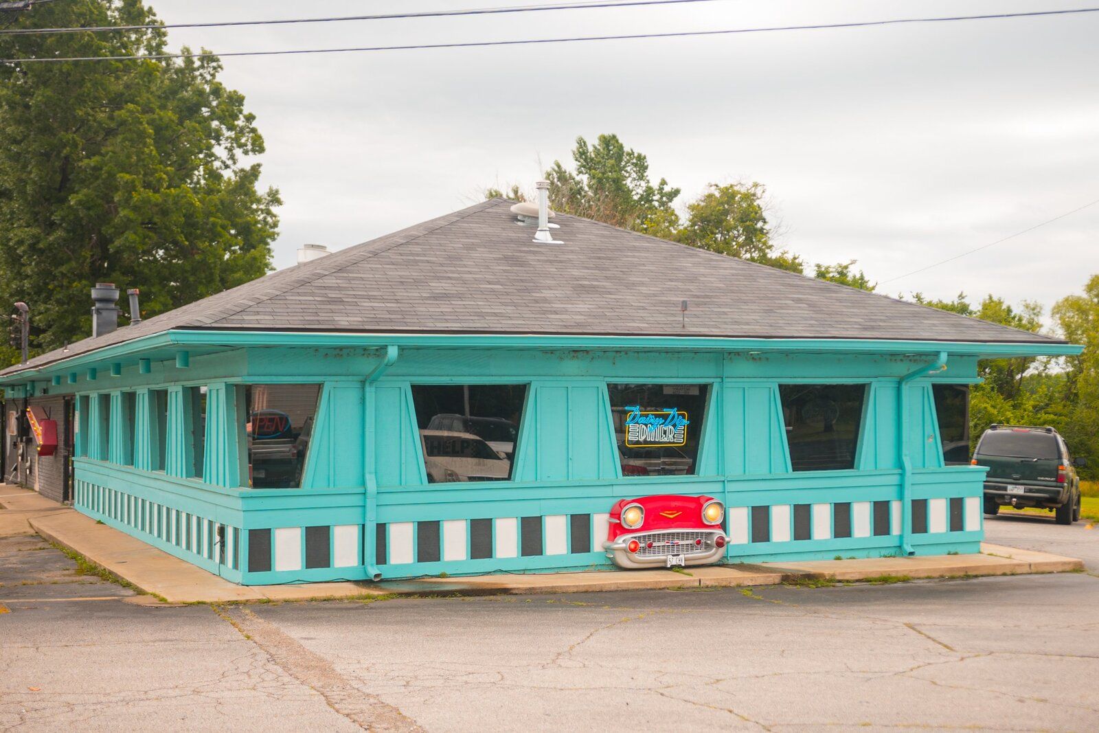 The teal Van Buren diner with a cherry-red car parked out front